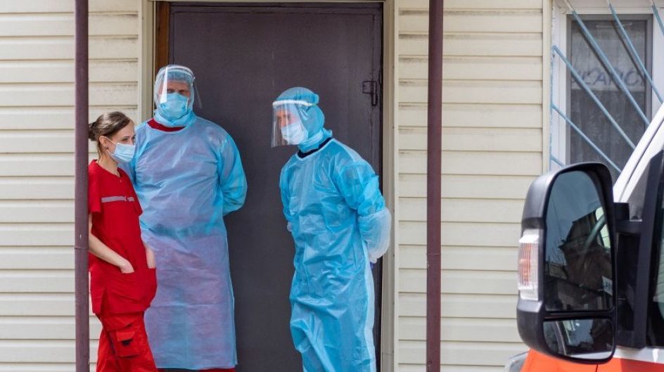 Healthcare workers in Ukraine treating COVID-19 patients during 2020 pandemic wave with hospital equipment and protective measures