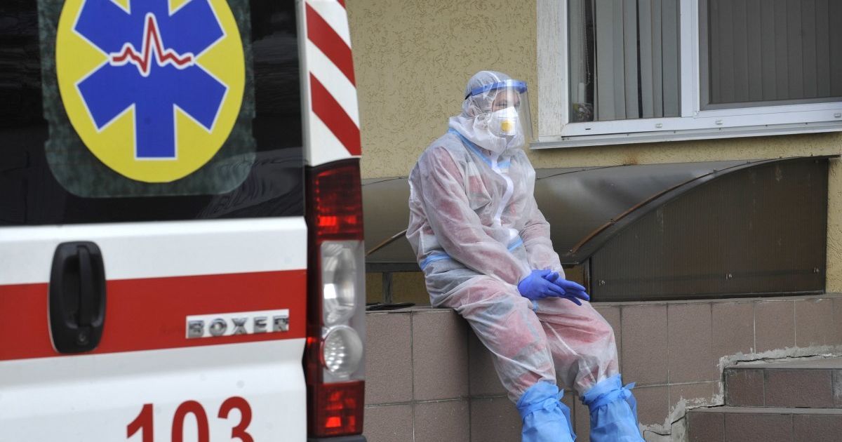 Ukrainian healthcare workers treating COVID-19 patients in hospital wards during early 2021 pandemic surge with protective equipment