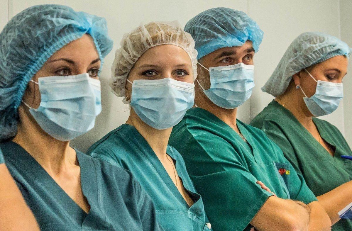 Ukrainian healthcare workers treating COVID-19 patients in hospital wards during early 2021 pandemic surge with protective equipment and medical response