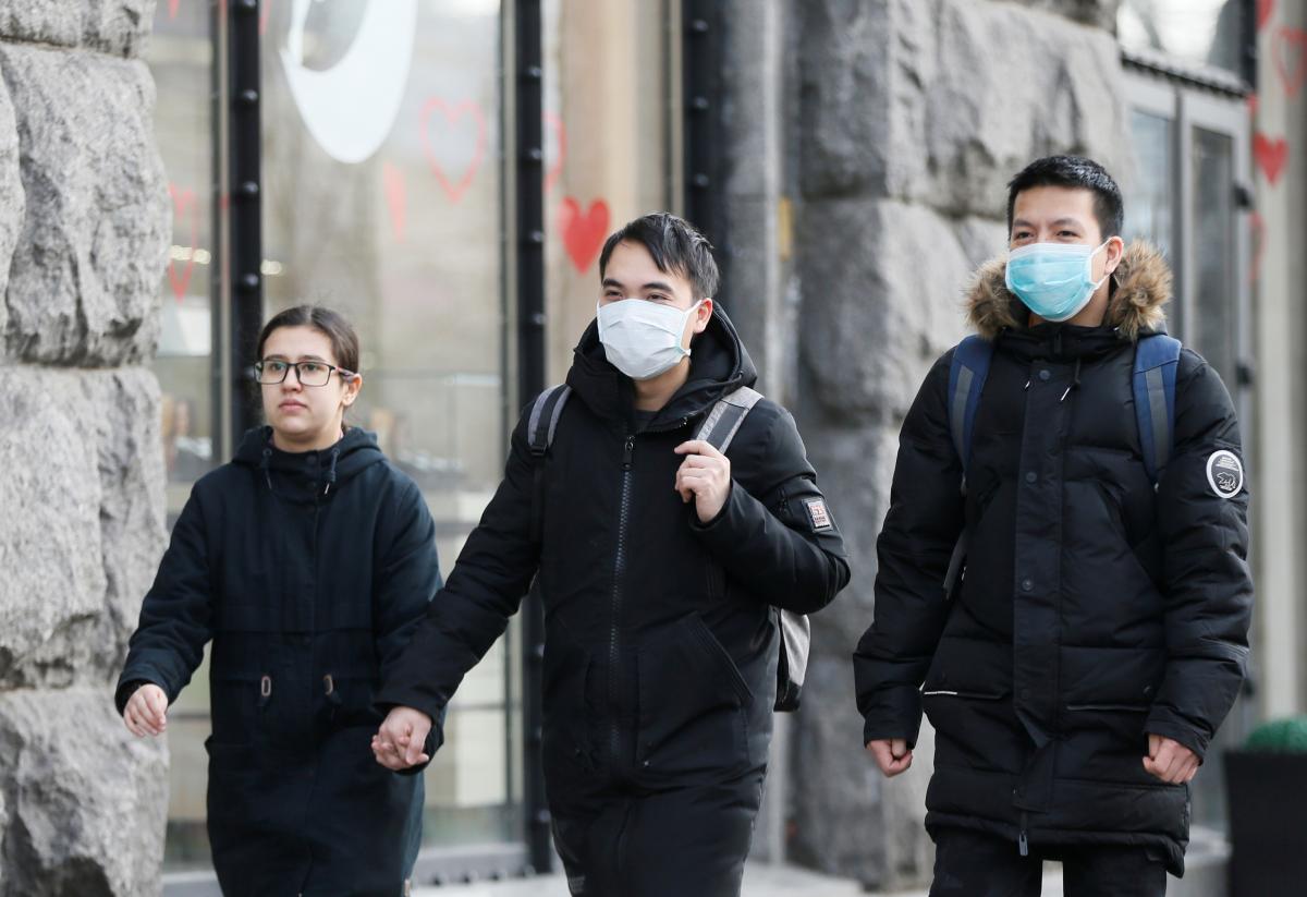 Ukrainian healthcare workers treating COVID-19 patients in hospital wards during early 2021 pandemic surge with protective equipment and medical care