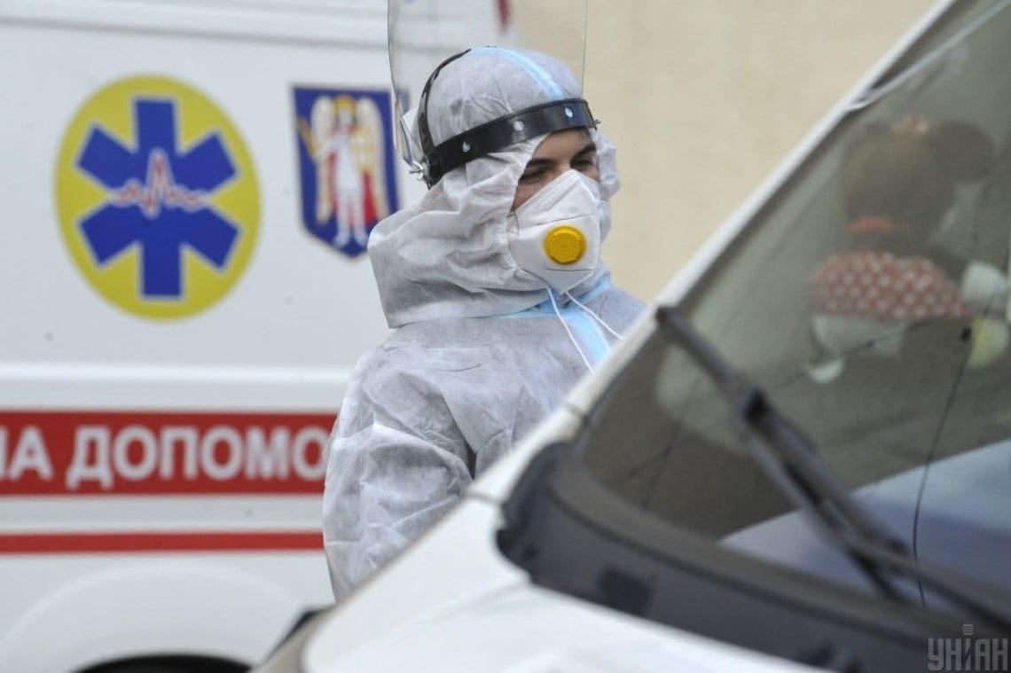 Medical workers treating COVID-19 patients in Ukraine hospital during ongoing pandemic crisis with protective gear and equipment