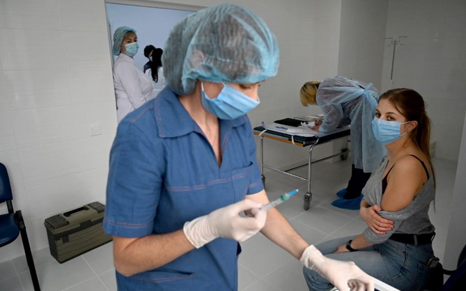 Healthcare workers in Ukraine track COVID-19 case trends and hospital data as infection rates continue to gradually decline in 2021
