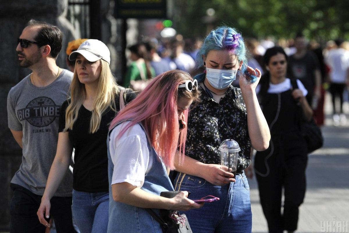 Healthcare workers analyzing COVID-19 statistics in Ukraine during Day 491 pandemic update showing national health trends
