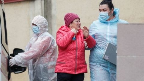 Healthcare workers in Ukraine wearing protective masks and medical gear during COVID-19 pandemic response in hospital setting