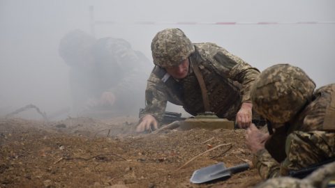 Ukrainian soldiers positioned in trench on eastern frontline as artillery shelling intensifies during Donbas conflict escalation