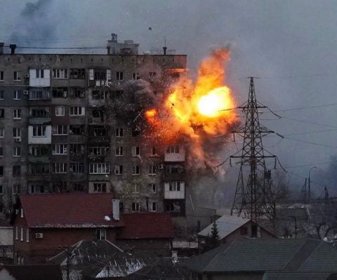 Civilians in devastated Mariupol under siege, defiant faces and destroyed streets captured as a symbolic message of survival and resistance under occupation.