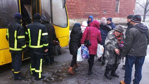Mariupol residents boarding buses under Russian occupation, facing forced deportation across the border into Russia or occupied territories.