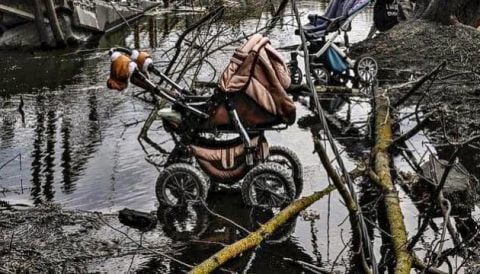 Ukrainian children’s shoes left at memorial for young lives lost in Russian invasion — symbolic tribute to children killed or wounded by shelling.