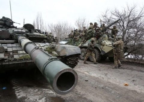 Smoke rises from war-torn Ukrainian cityscape on March 23 2022 as Russian shelling damaged bridges, residential districts and evacuation routes.