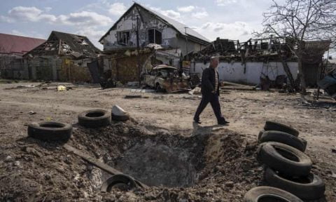Smoke rising over Ukrainian city after March 26, 2022 Russian airstrikes, with soldiers and civilians amid war‑torn streets and frontline action.