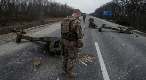 Ukrainian soldiers and civilians near Kyiv on March 29 2022 with smoke from shelling as peace talks and intense battles unfold. :contentReference[oaicite:3]{index=3}