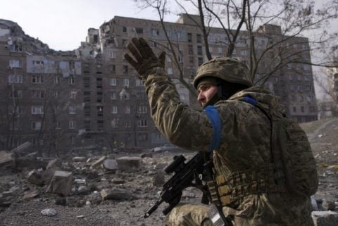 Ukrainian Azov Regiment fighters in Mariupol showing defiance and readiness with weapons amid siege and refusal to lay down arms against Russian forces.