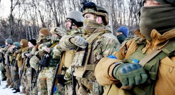 Azov Regiment deputy commander Svyatoslav “Kalyna” Palamar speaking into camera with war-torn Mariupol ruins behind him under siege.