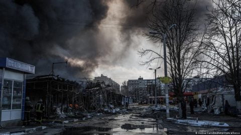 Mobile crematorium vehicle in Mariupol amid war damage, symbolizing alleged efforts to burn bodies and conceal evidence of atrocities by occupying forces.