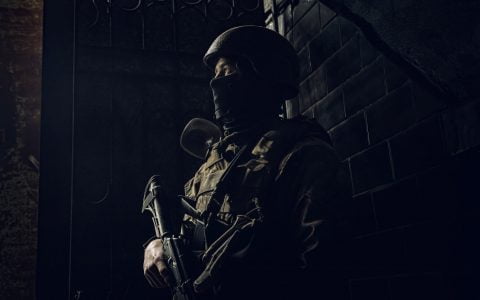 Ukrainian marine soldiers fighting in Mariupol urban battle, resisting Russian occupiers under siege with weapons and fierce determination.