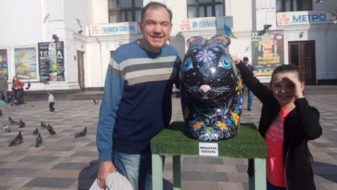 Portrait of Ukrainian water polo captain with Mariupol skyline overlay — tribute to his life and the wartime tragedy of his death and daughter’s capture.