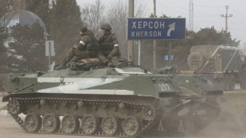 Kherson street scene with empty roads and damaged buildings, capturing civilian life under Russian occupation and firsthand testimony of hardship and resilience