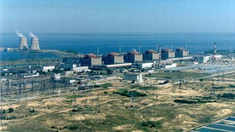 Zaporizhzhia NPP aerial view showing plant and surrounding towns under threat zone, illustrating potential evacuation risk in Ukraine war.
