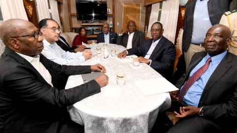 African delegation members at press briefing with Ukrainian conflict in background illustrating disinformation and denial controversy