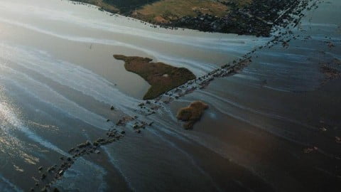Dramatically receding waters of the Kakhovka Reservoir near Nikopol after dam destruction with exposed banks and low water levels