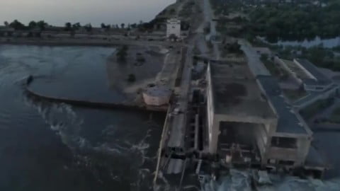 Kakhovka Hydroelectric Power Plant dam destroyed with debris and floodwaters as investigators and responders assess remote explosion evidence.