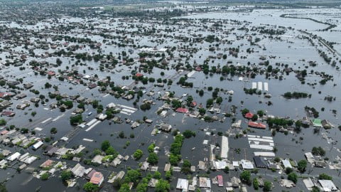 Flooded streets and submerged homes in occupied Kherson left bank after dam destruction, symbolizing civilian tragedy and humanitarian crisis.
