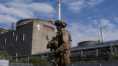 Zaporizhzhia Nuclear Power Plant under occupation with Russian soldiers and military equipment, highlighting nuclear safety and mining threat.