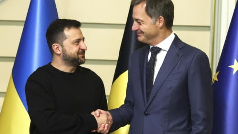 Belgian and Ukrainian flags near EU institutions symbolizing creation of €1.7 billion support fund from frozen Russian asset proceeds.