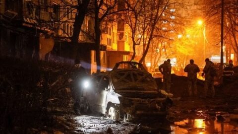 Kyiv skyline with smoke and damaged buildings after a Russian ballistic missile attack, showing fire crews and debris across the city.