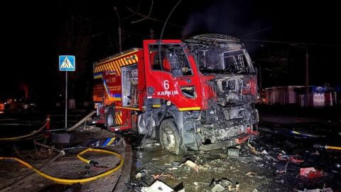 Nighttime drone strike aftermath in Kharkiv region: smoke rises over damaged buildings and rescuers work amid Russian UAV attacks on civilians and personnel. :contentReference[oaicite:2]{index=2}