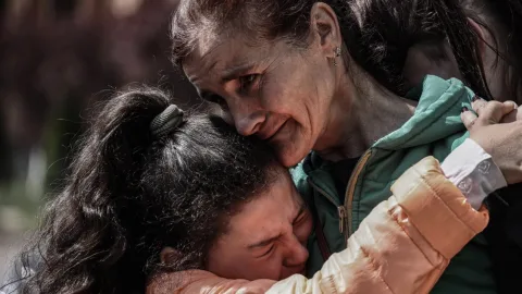 Ukrainian mother cradling her child in a bomb shelter as sirens wail and war looms — the reality of raising children under conflict in Ukraine. :contentReference[oaicite:3]{index=3}