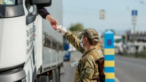 Ukrainian truck drivers being stopped and detained by TCC officials at international flight return point amid forced mobilization claims and cargo abandonment.