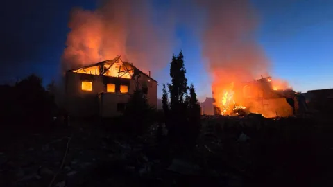 Ukrainian city under heavy fire on May 10 2024 with smoke, damaged buildings and frontline explosions across multiple regional attacks.