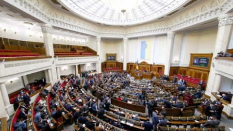 Ukrainian parliament session in Verkhovna Rada chamber symbolizing debate over controversial corruption law replacing prison with fines