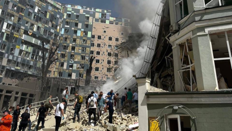 Aftermath of Russian missile strikes across Ukraine on July 8 2024 showing damaged buildings, emergency crews and civilians amid rubble.