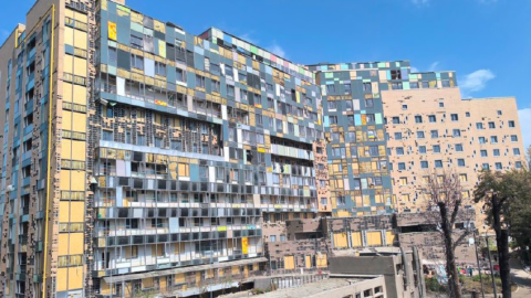 Damaged children’s hospital in Kyiv after missile strike with emergency responders and debris symbolizing destruction and urgent reconstruction efforts