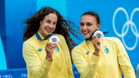 Ukrainian Olympic athletes celebrating historic 150th medal milestone at Summer Games podium during award ceremony