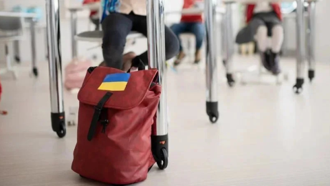 Ukrainian refugees at border crossing moving into Europe amid ongoing war migration wave and economic uncertainty 2025 forecast