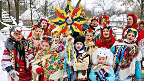 Ukrainian festive holiday table with traditional dishes like kutia, salads and desserts being prepared for Christmas or New Year celebration.