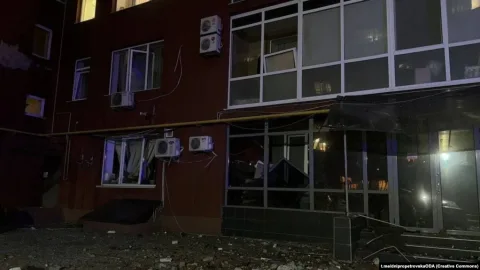 Emergency responders tending to wounded civilians and damaged buildings after a Russian missile strike in Dnipro, Ukraine.