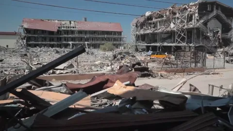 Devastated seaside buildings and rubble in Zatoka after Russian shelling, showing smashed windows, collapsed roofs and debris‑strewn streets. :contentReference[oaicite:1]{index=1}