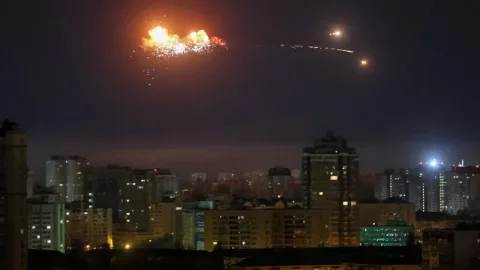 Nighttime aftermath of Russia’s massive combined air attack on Kyiv showing damaged buildings, emergency crews and active air defenses.