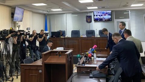 Oleksiy Chernyshov leaving court after bail posted, with media and security present in high‑profile Ukrainian corruption case.