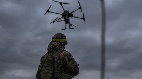 Array of military unmanned aerial vehicles lined up in a Ukrainian defence manufacturing facility, showcasing mass drone production capacity.