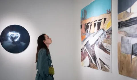 Visitors at a vibrant art exhibition in Kyiv’s cultural scene featuring paintings, installations and historical displays in June events.