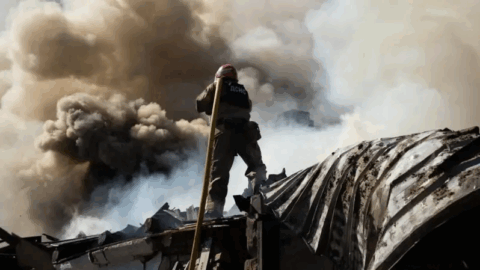 Poltava city aftermath after Russian drone strike with damaged recruitment center building, smoke and emergency responders