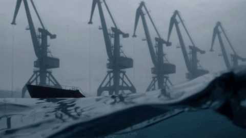 Cargo vessel loaded with grain leaving an occupied port on the Sea of Azov, part of the scheme to export stolen Ukrainian agricultural products internationally.