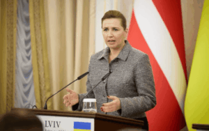 Denmark Prime Minister with Danish flag – military aid decision 2025