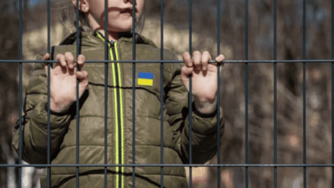 Ukrainian orphan children walking with border guard officers – child trafficking case