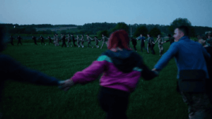 Visitors exploring a contemporary art exhibition that reflects themes of war, color contrast, and human solitude during a February cultural event.